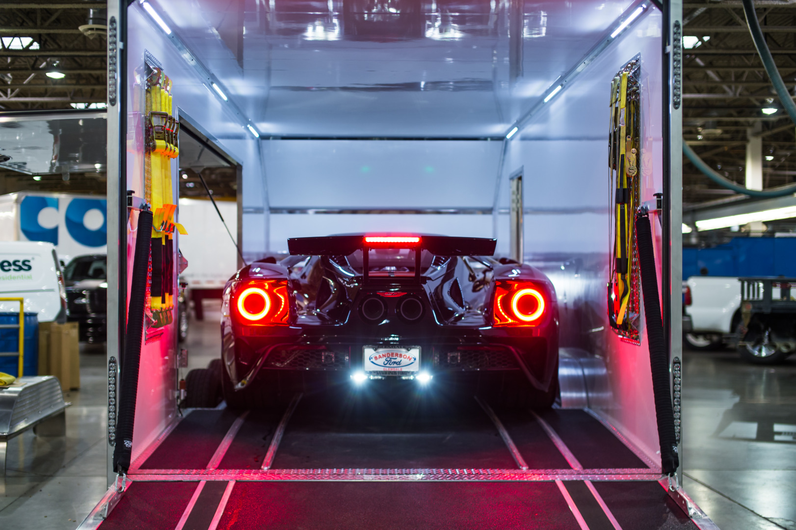 Black Ford Gt Backing Out Of A Jimglo Elite Enclosed Car Trailer.