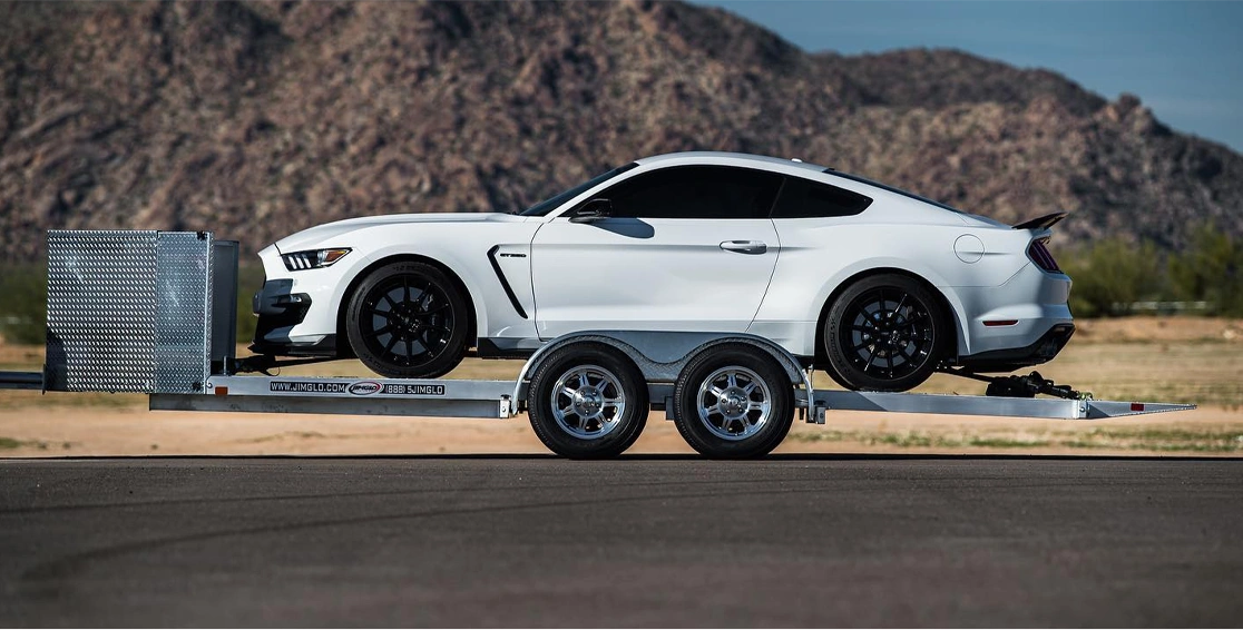 Home 10 white-supercar-in-a-open-trailer