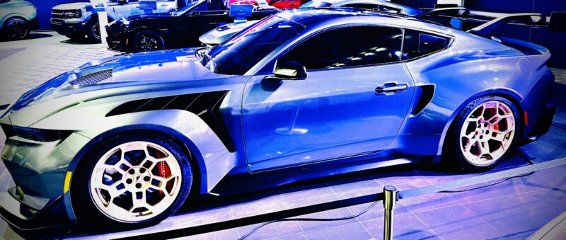 a blue sports car parked in a showroom ford mustang gtd